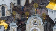russian strikes kill 11 and set historic cathedral in kyiv ablaze